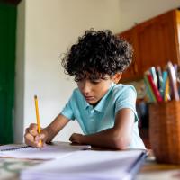 Boy doing homework at a table.