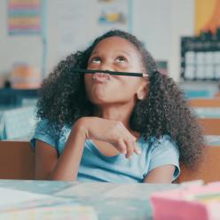 Distracted girl playing with a pencil