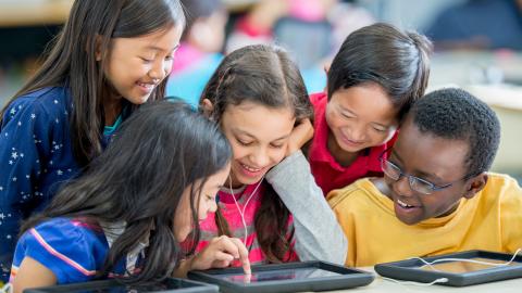 Kids looking at ipads in class