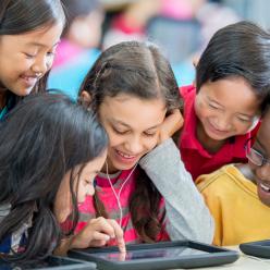 Kids looking at ipads in class