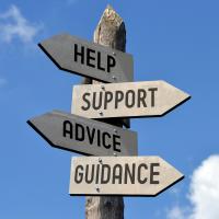 A signpost that reads help, support, advice, and guidance.