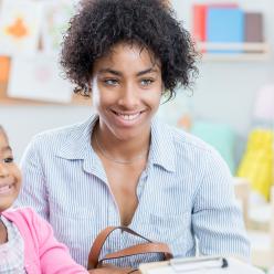 Mother and daughter talking to a teacher